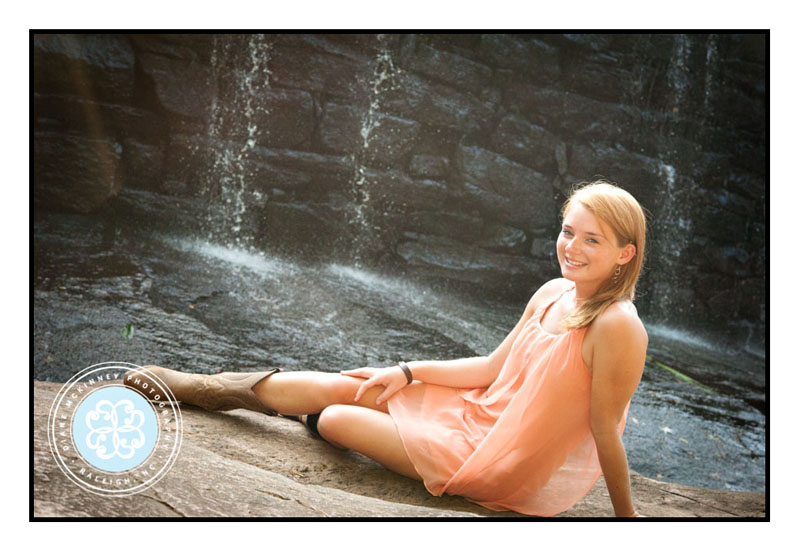 Senior girl in dress and boots waterfall