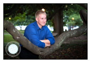 Senior Boy Smiling while leaning on tree branch